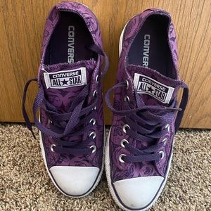 Rose patterned low top Converse sneakers.